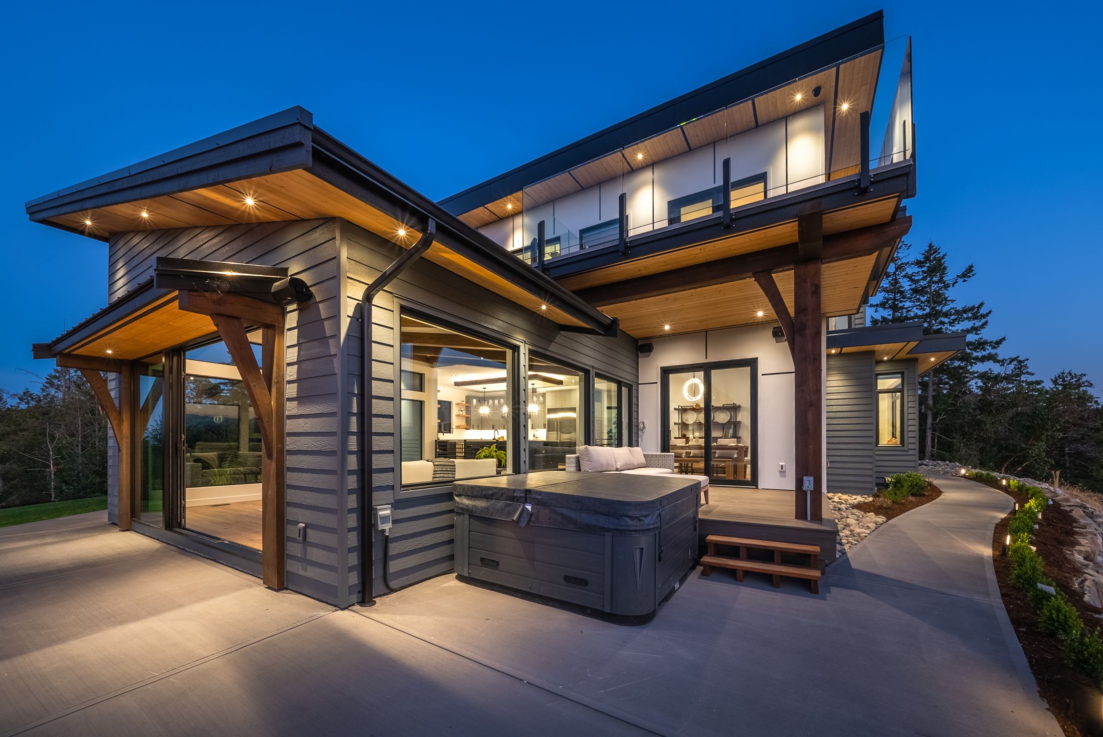Back patio of a custom home glowing warmly at night