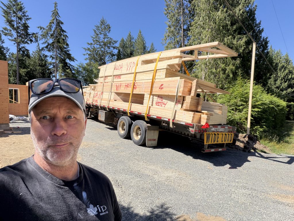 VIP Homes team member with a delivery of lumber arriving on site