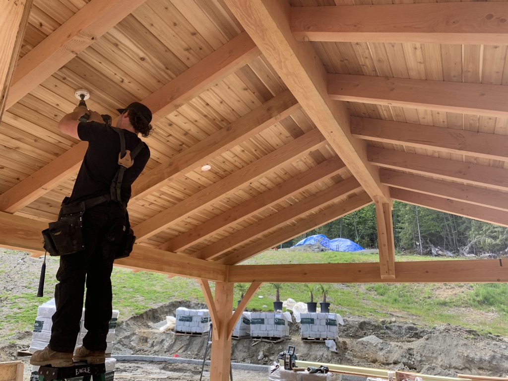 VIP Homes carpenter working on an exposed timber roof structure
