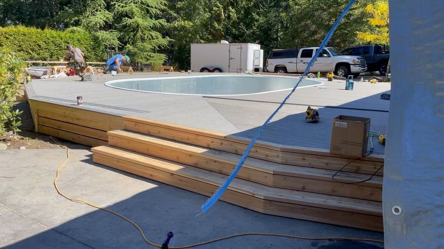 Crew doing finishing work around a new pool